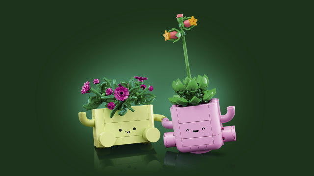 Gull og rosa LEGO blomsterkasser med smilende ansikter og fargerike blomster