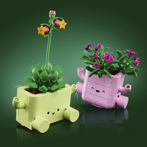 Gull og rosa LEGO blomsterkasser med gull- og lilla blomster, perfekt som leker for barn.